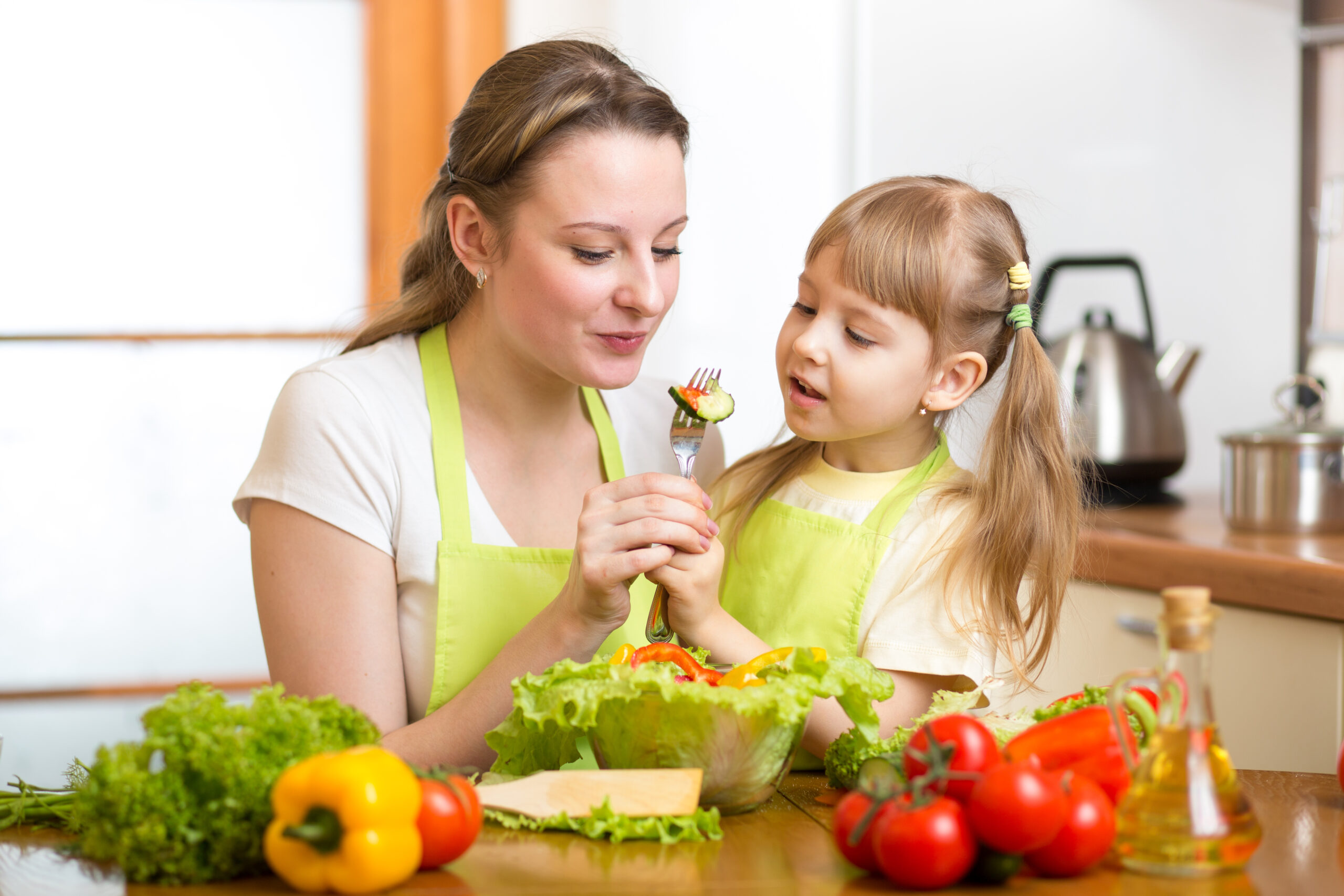 mother child sharing salad lettuce