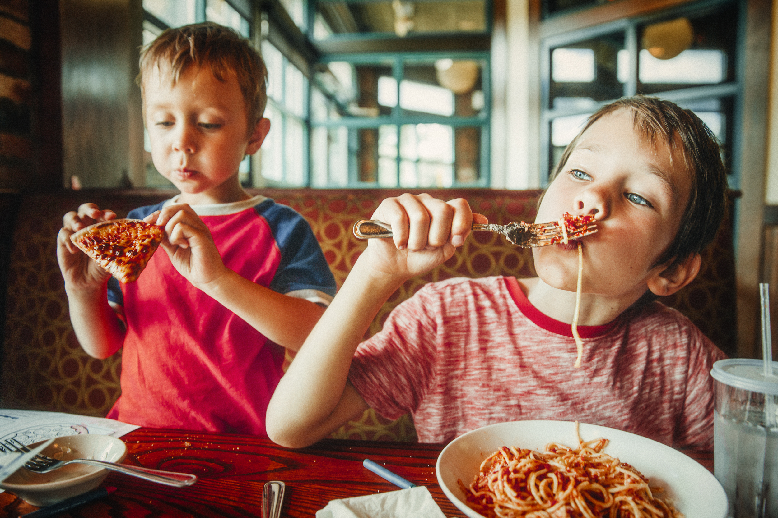 Kids,Eat,Pizza,And,Pasta,At,Cafe.,Children,Eating,Unhealthy